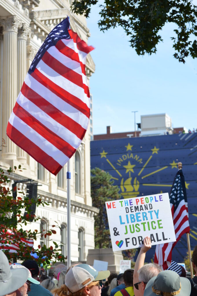 Picture of a sign with writing that says Liberty and Justice for all